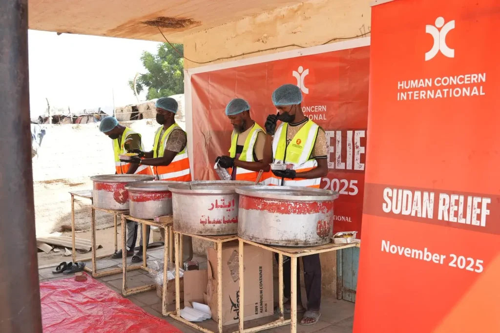 Human Concern International team cooking and preparing emergency meals for families affected by the Sudan crisis.