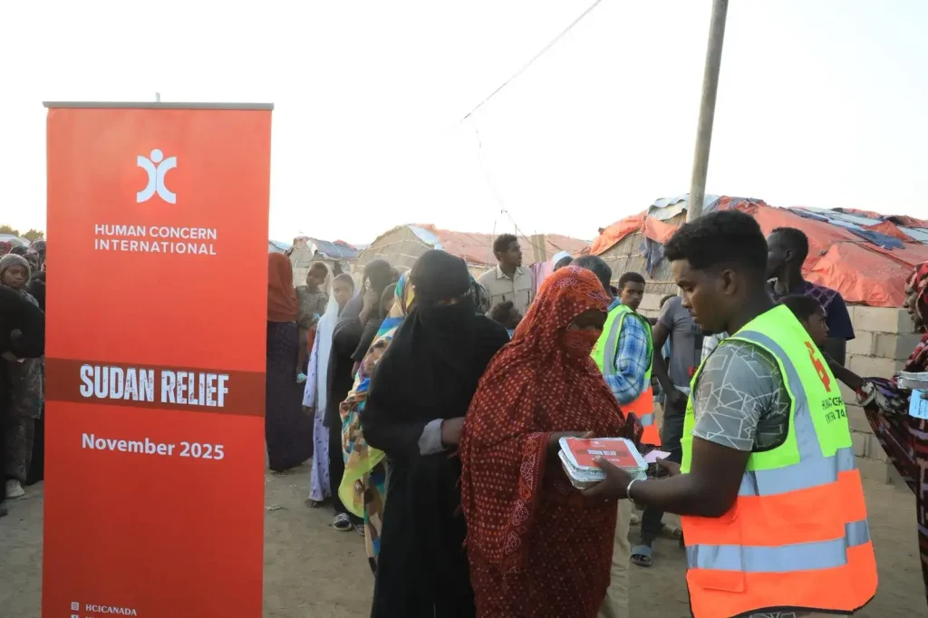 Human Concern International volunteers distributing meal packs to displaced women during the Sudan Relief campaign
